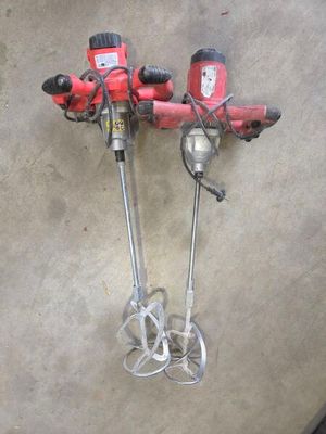 two tools that are sitting on the floor next to each other