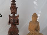 three statues of buddhas sitting on a small table