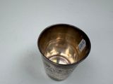 a silver cup that is sitting on a table