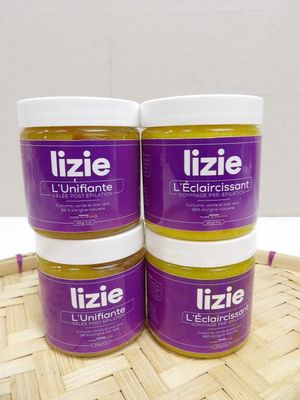 three jars of lizie ' s ultimate lip butter sitting on top of a wooden tray