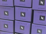 several boxes of perfume are stacked on a shelf in a store