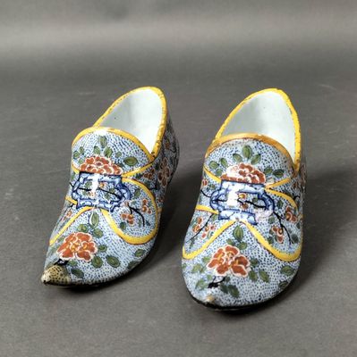 pair of blue and yellow clogs with flowers on them