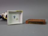 a small white and blue vase and a small wooden box
