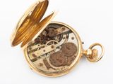 pocket watch on a white background showing the movement of the watch