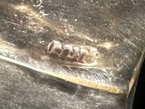 a close up of a piece of metal with a piece of writing on it