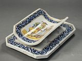 a blue and white plate with a spoon in it
