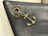 an anchor on a wallet with a chain attached to it