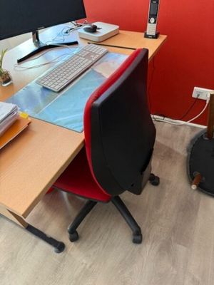 a desk with a computer monitor, keyboard, mouse, and other items on it