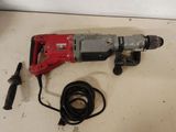 a drill that is sitting on a table next to a cord