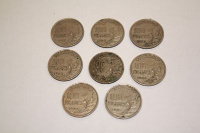 six different coins sitting on top of each other on a white surface