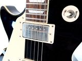 a black and white electric guitar sitting on a table