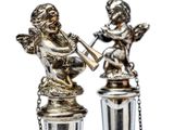 pair of silver figurines of angels playing musical instruments
