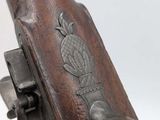 an old gun with a wooden handle and a metal handle