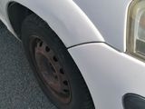 a close up of a white van with a flat tire