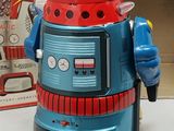 a toy robot that is sitting next to a box