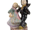 a figurine of a boy and a girl on a rock