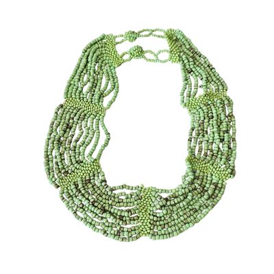 a close up of a green necklace on a white background