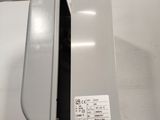 a close up of a metal object with a white label on it