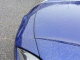 a blue car parked on the side of the road