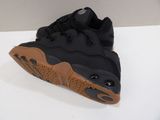 a close up of a pair of black sneakers on a white surface