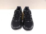 a pair of black running shoes on a white surface