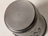a silver container with a lid sitting on a table