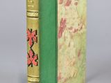 a green book with a red design on the cover