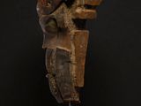 a wooden sculpture of a man ' s head on a stand