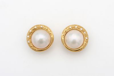a pair of pearl and gold earrings