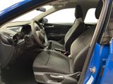 the interior of a blue car with the door open and the driver ' s seat down
