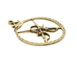 an image of a gold pendant with scissors and a star on it