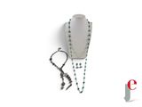 a necklace, bracelet, and earring on a white background