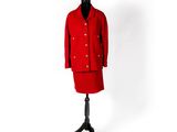 un manteau rouge sur un mannequin, posé devant un fond blanc