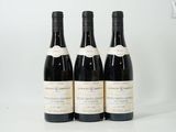 three bottles of wine sitting on top of a table next to each other