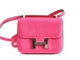 pink leather cross body bag with two metal handles