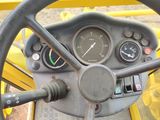 a close up of a steering wheel and dashboard of a tractor