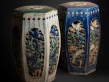 two vases sitting side by side on a black background