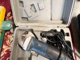 a tool in a case that is sitting on a rug
