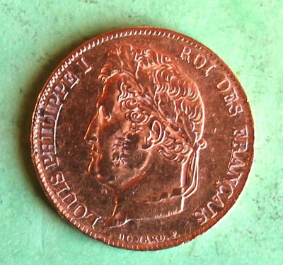 a close up of a penny on a green surface