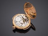 an old pocket watch sitting on top of a black surface