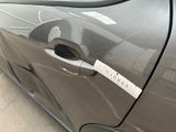 a car door handle with a sticker on it