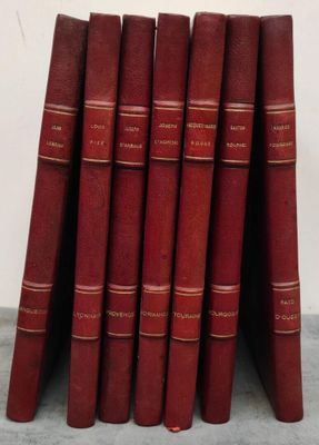 several red books stacked on top of each other on a table