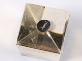 a small box with a clock on it on a white surface