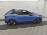 a blue car is parked in a room with a checkered floor
