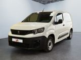 the small white van is parked in a large room