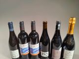 several bottles of wine are lined up in a row on a table