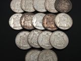 a lot of coins sitting on a black surface