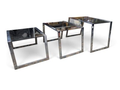 two tables with a glass top and metal legs on a white background
