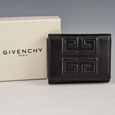 a givenchy black leather wallet with a white box