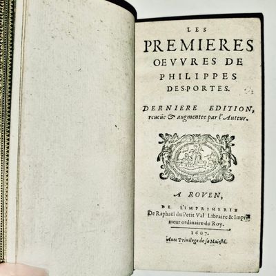 someone is holding an open book with a picture of a bird on it